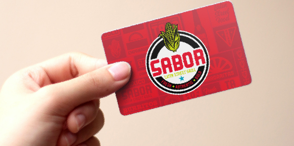 Hand holding a Sabor Latin Street Grill gift card